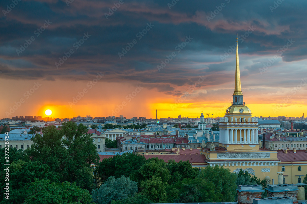 Fototapeta premium Saint Petersburg, Russia. Storm clouds on the horizon, beautiful cityscape in a thunderstorm at sunset. View of the Admiralty and the city