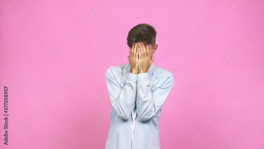 Young student teenager man pointing with forefingers to a copy space, expressing excitement and desire Young student teenager man pointing with forefingers to a copy space, expressing excitement and desire