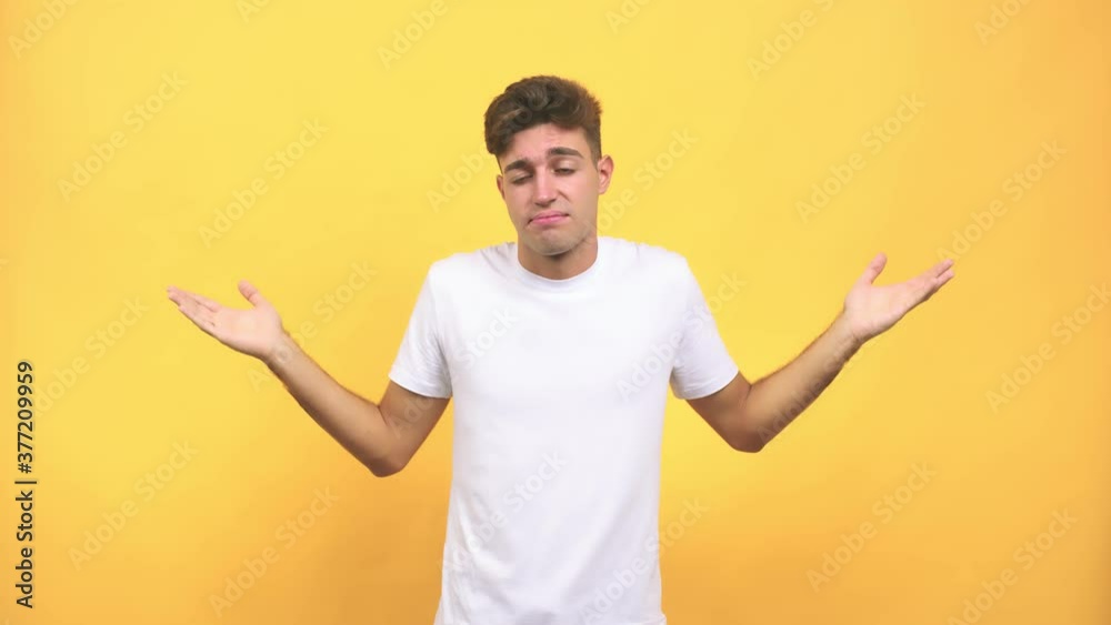 Young caucasian student man doubting and shrugging shoulders, concept of indecision and insecurity