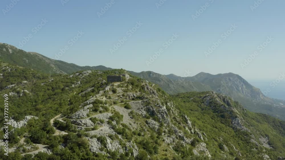 Aerial view of medieval fortress Fort Kosmac in Montenegro. Drone shot ruin of an old stone fortress on the top of the hill. Aerial view of medieval fortress Fort Kosmac in Montenegro. Drone shot ruin of an old stone fortress on the top of the hill.