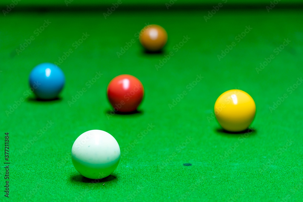 Different colored snooker balls scattered on the snooker table. Different colored snooker balls scattered on the snooker table.