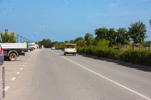 Canvastavla car on the road through the streets of formentera in summer