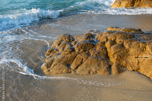 Shore water in the evening on a beach in Ikaria, Greece photo