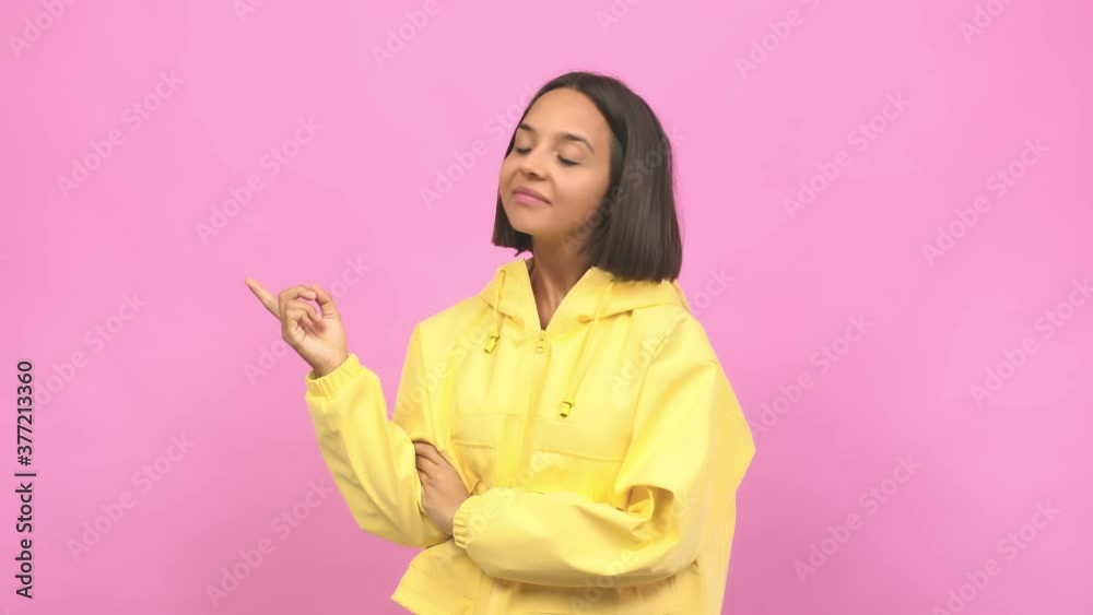 Young indian woman pointing to the side, smiling surprised presenting something, natural and casual Young indian woman pointing to the side, smiling surprised presenting something, natural and casual