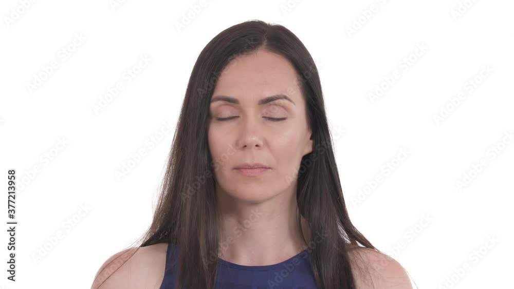 Close up portrait of Caucasian woman standing at camera and blinking very fast. Gymnastic to relieve eye strain. Isolated on white background