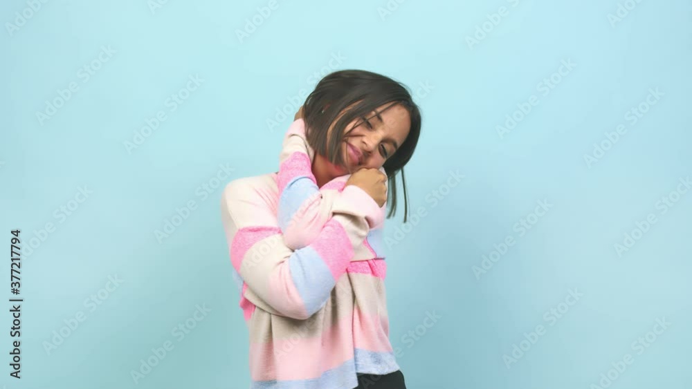 Young indian woman giving a hug, feeling of pride and happiness, affection towards yourself Young indian woman giving a hug, feeling of pride and happiness, affection towards yourself