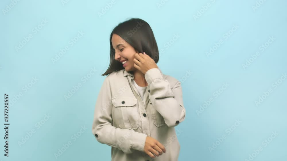 Young indian woman dancing and having fun, moving arms listening to music Young indian woman dancing and having fun, moving arms listening to music