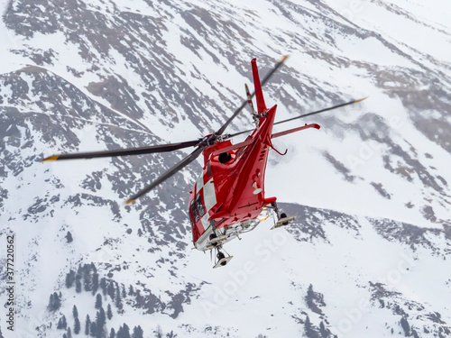 Alpine rescue helicopter in winter photo