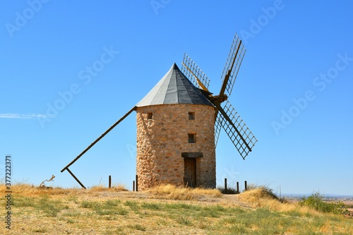 Windmill built in stone and wood in Belmonte. Sunny day, blue sky.