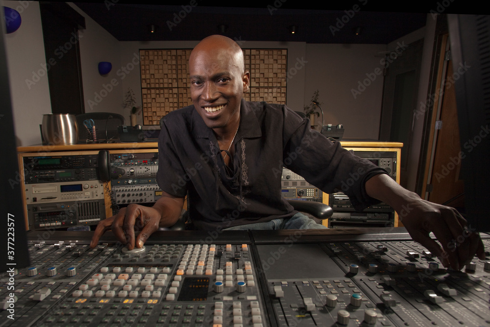 Portrait of smiling man working at audio control panel Portrait of smiling man working at audio control panel