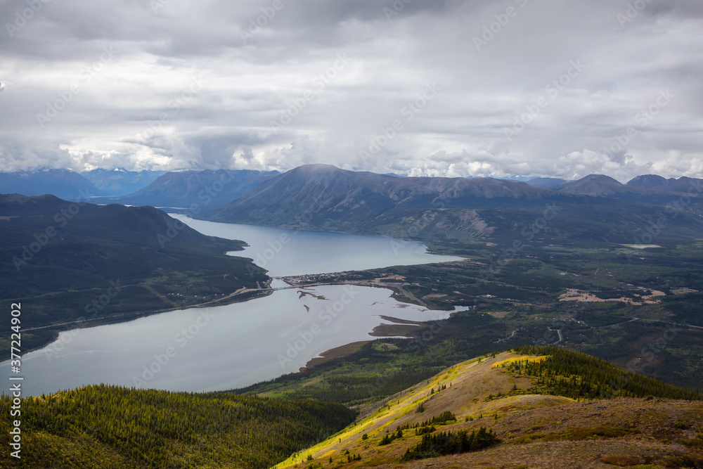 Beautiful View of a small Touristic Town, Carcross, surounded by Canadian Mountain Landscape. Located near Whitehorse, Yukon, Canada.