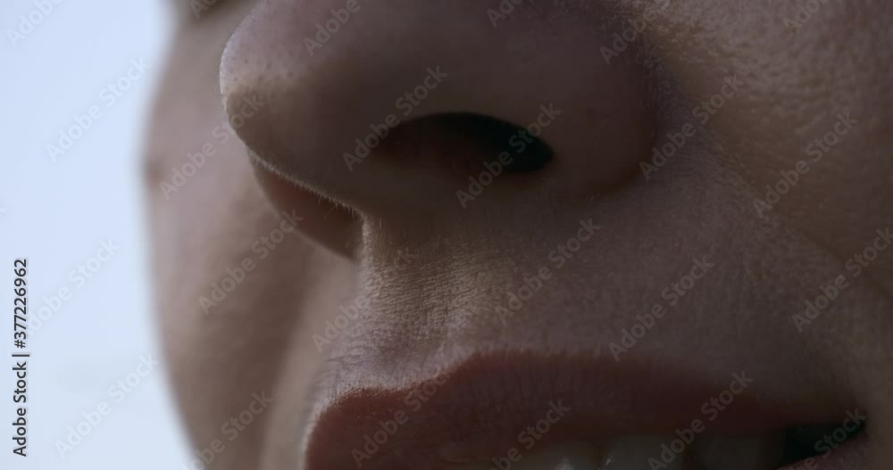 Tilting up close-up Female Face. Mouth Lips Nose Eyes. Outdoors Natural Lighting Morning Evening Time