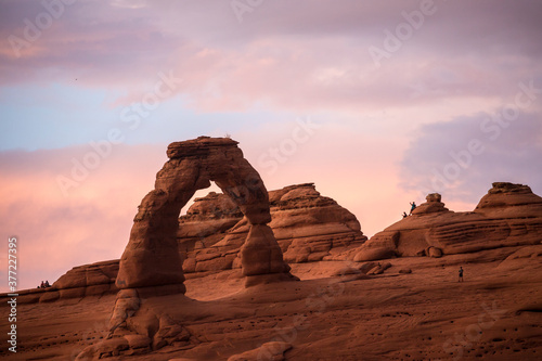 Landscape view of the Delicate Arch at sunset in Arches National Park after a thunderstorm (Utah).