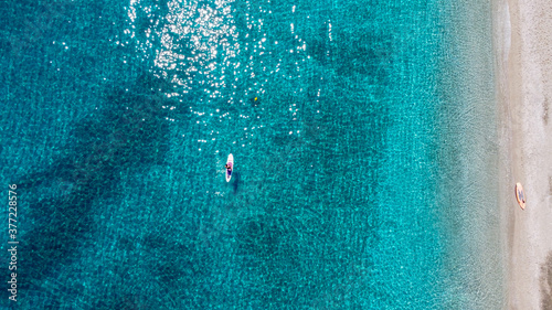 Lonely canoe on the Aegean coast to Saranta beach at Pelion Peninsula, Greece. Photo taken withe Drone.