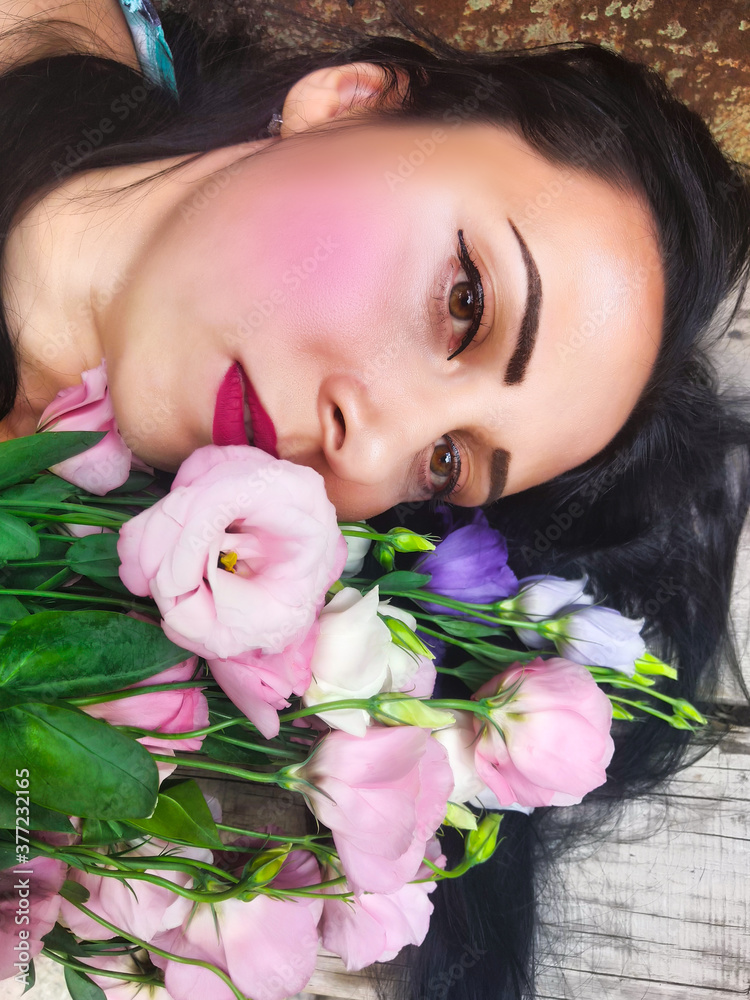 closeup woman portrait with pink estoma flowers
