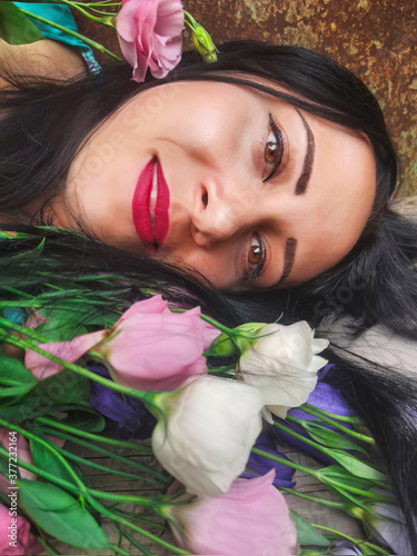 closeup woman portrait with pink estoma flowers