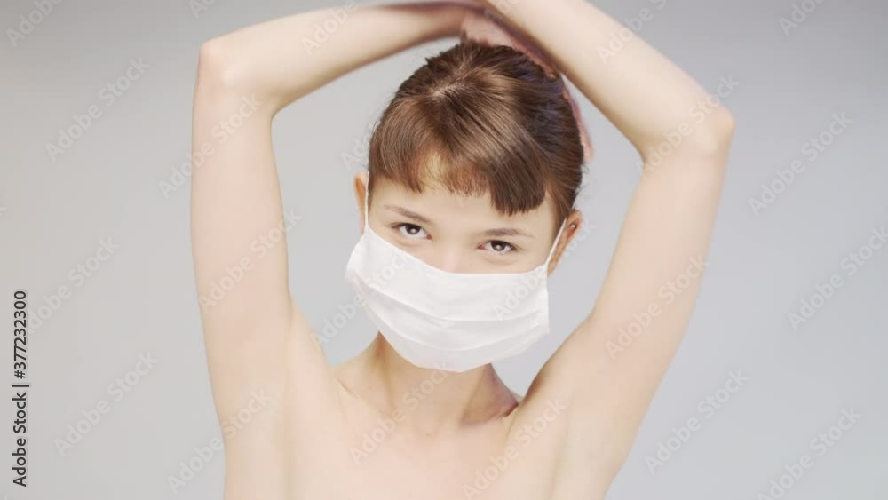 Portrait of a cute happy girl wearing medical face mask.