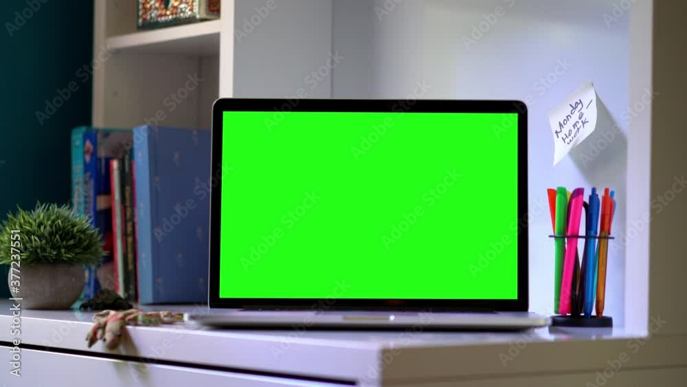 Push Over Computer Dolly push in to laptop computer on children’s desk with green screen ...