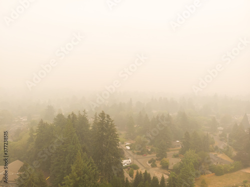 Beaverton Oregon city in smoke, behind burning forests, top view, news