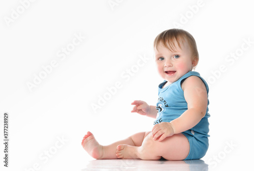 Happy baby boy sitting and laughing