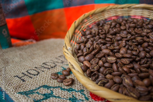A wicker made of natural fiber full with roasted coffee beans in Honduras country