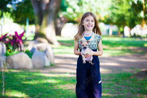 beautiful girl with a small puppy photo