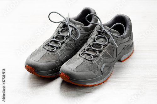 trekking sneakers with red sole, white background
