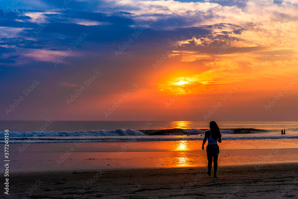 Silhouetted Person on beach at Sunset, Ocean 