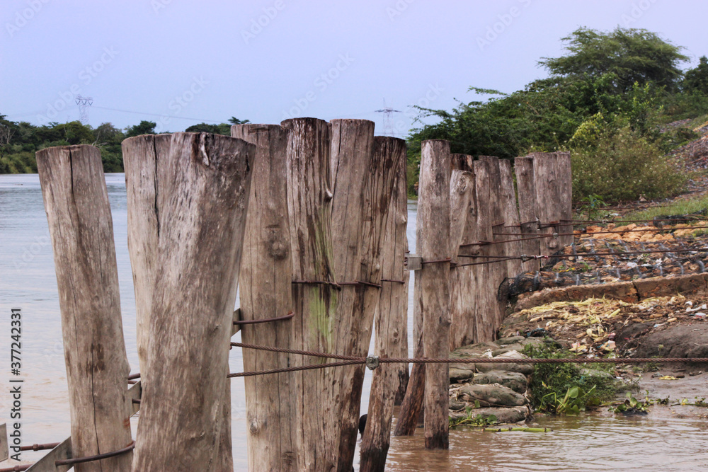 wood barrier in dique channel, santa lucia, atlantico, colombia wood barrier in dique channel, santa lucia, atlantico, colombia
