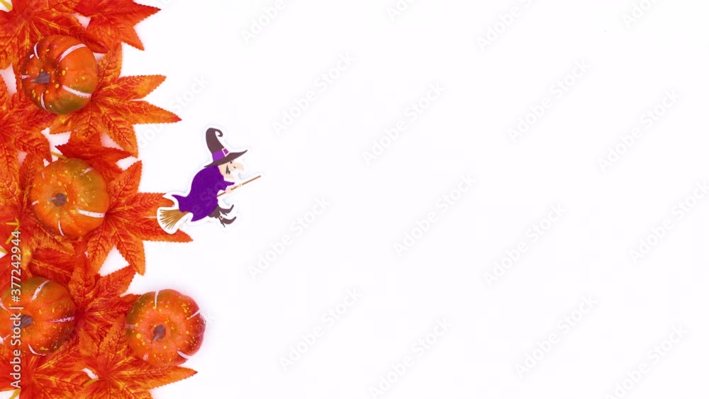 Halloween decor and autumn leaves appear on white theme. Stop motion Halloween decor and autumn leaves appear on white theme. Stop motion