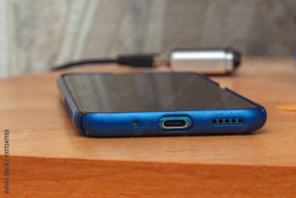 smartphone in a blue protective case on the table