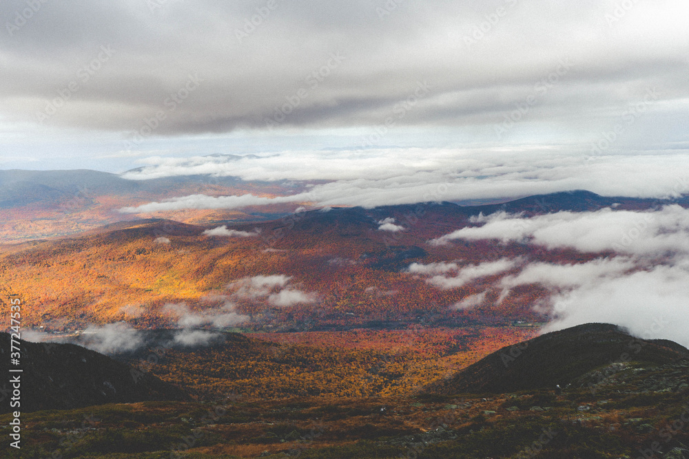 Above the clouds in fall mountains. 