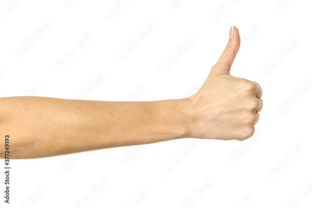 Thumb up. Woman hand gesturing isolated on white Thumb up. Woman hand gesturing isolated on white