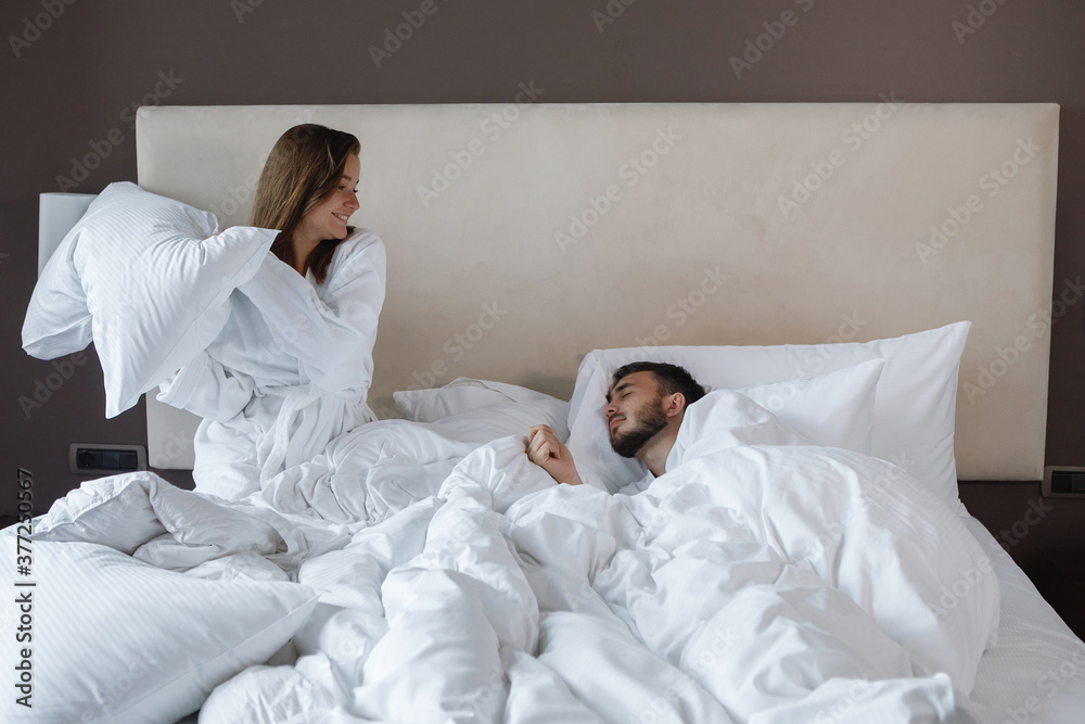 Fototapeta premium Young cute couple, man and woman in bed.