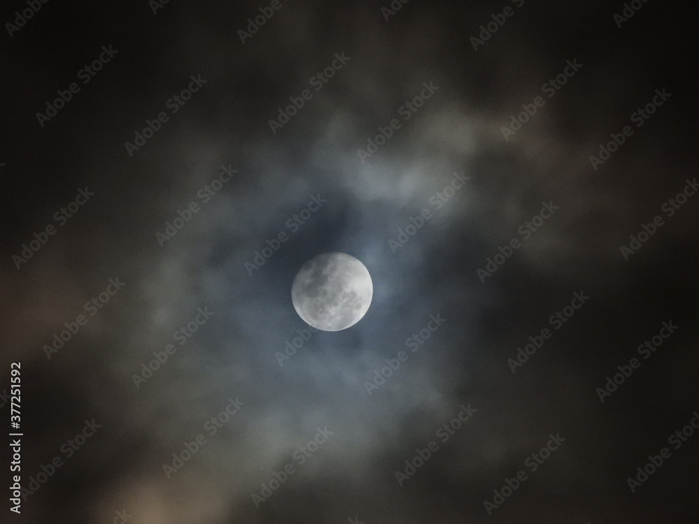 Moon peaking through cloud