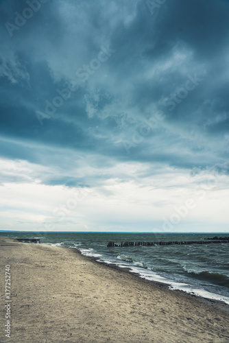 Storming sea with dark clouds in the autumn's morning. Sea landscape.