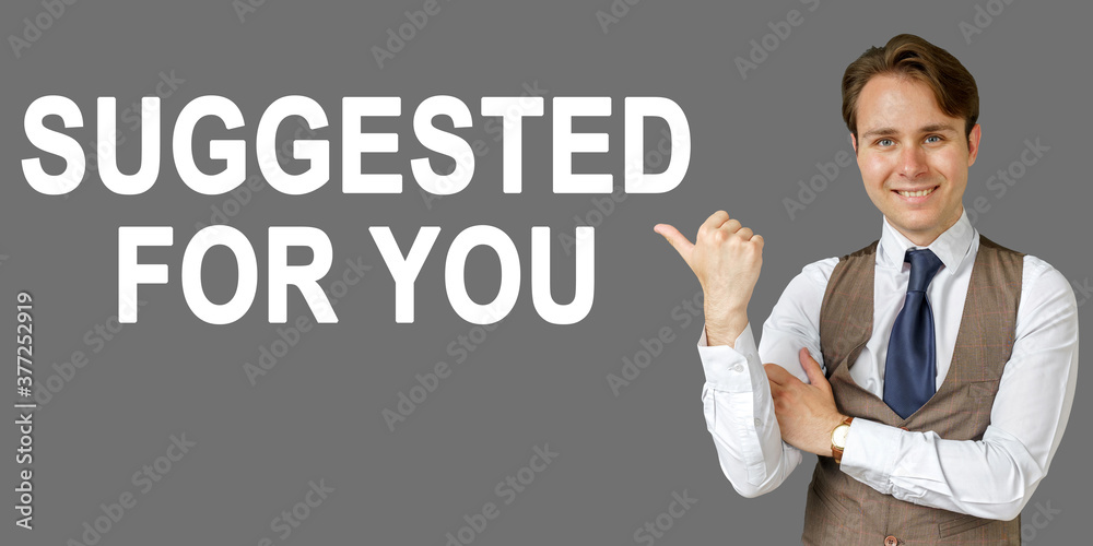 Emotional portrait of businessman showing right hand gesture on text - SUGGESTED FOR YOU. Gray background. Emotional portrait of businessman showing right hand gesture on text - SUGGESTED FOR YOU. Gray background.
