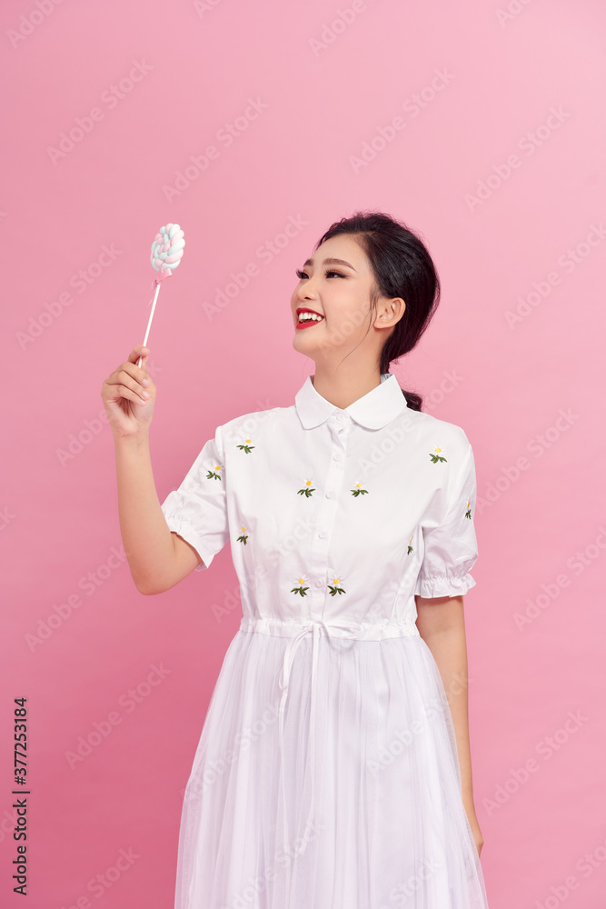 Young pretty woman with candies on colorful background Young pretty woman with candies on colorful background