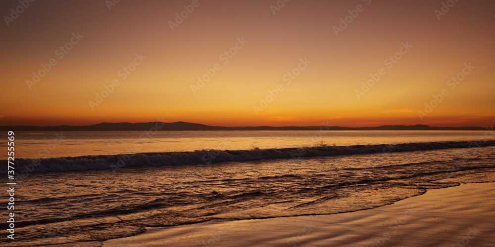 the waves along the shore on this wonderful beach too calling it a day after the sunset, a beautiful serene view all around with the vibrant diffused colours of nature. the waves along the shore on this wonderful beach too calling it a day after the sunset, a beautiful serene view all around with the vibrant diffused colours of nature.