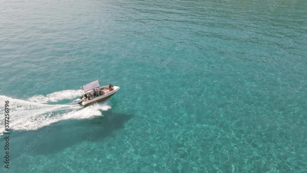 Chasing the boat ont the water with turquoise clear water in Zakynthos Greece.