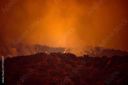 Orange sky over the mountains of California. Fires near Los Angeles. Smoke pollution in US air.