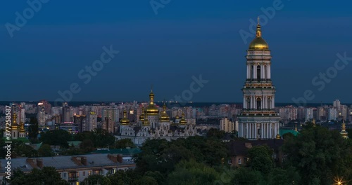 Turning on the night illumination of the Kiev Pechersk Lavra against the background of the sunset sky, Kiev, Ukraine. Time Lapse photo