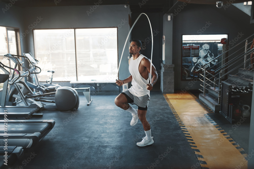 Gym. Sportsman Jumping With Rope. Asian Man Using Sport Equipment For  Exercise. Sexy Guy With Strong, Healthy Muscular Body Training At Sports  Center. Cardio Workout And Bodybuilding As Lifestyle. Stock Photo