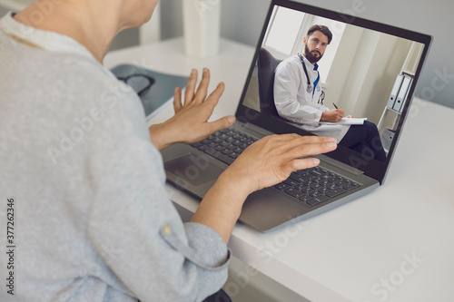 Woman patient communicating with confident man doctor therapist onine during videocall on laptop © Studio Romantic