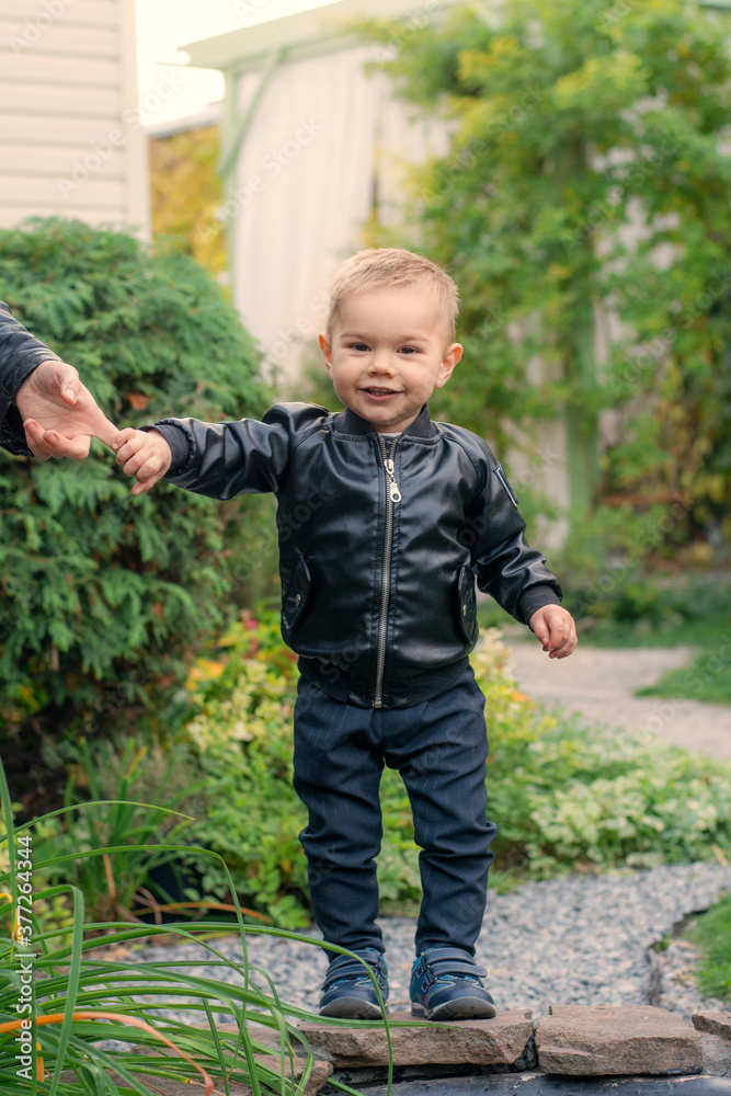 Little boy walking in the autumn park. Stylish child Little boy walking in the autumn park. Stylish child