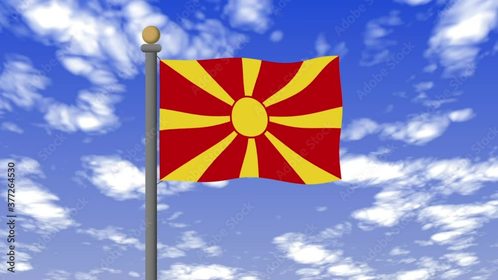 北マケドニアの国旗　背景の空には雲が流れています。