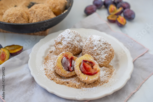 Typical Austrian plum dumplings made of leavened dough and fresh plums photo