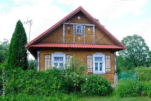 Beautiful wooden house with decorative shutters in the village, Podlasie, Poland. This area is called the Land of Open Shutters