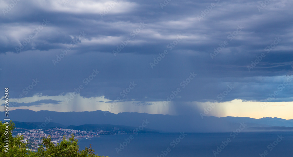 Dramatic storm scenery over the Adriatic Sea, with dark cumulus rain clouds