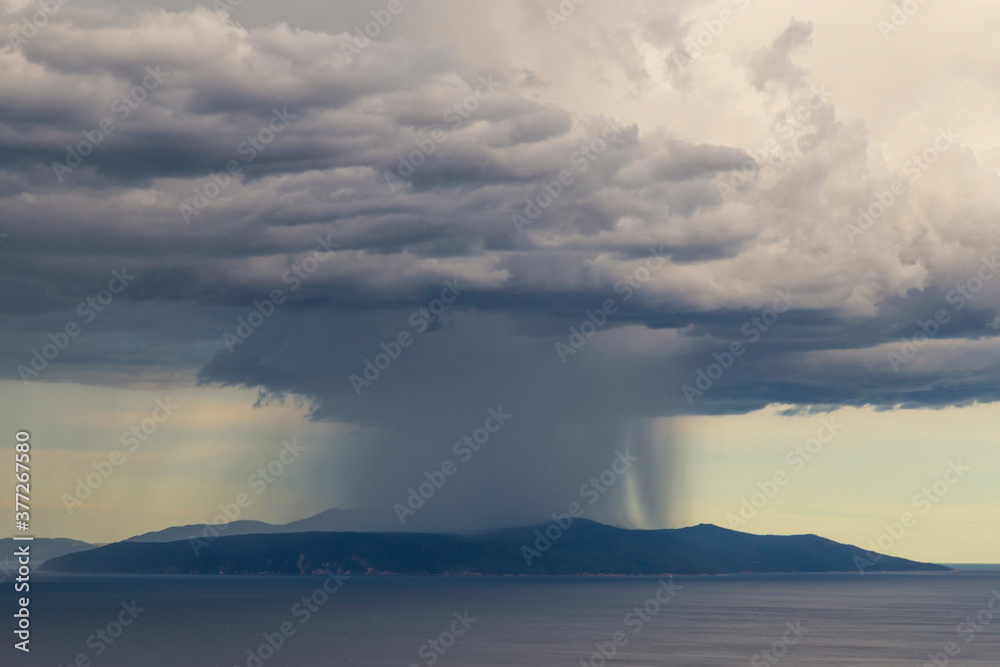 Dramatic storm scenery over the Adriatic Sea, with dark cumulus rain clouds